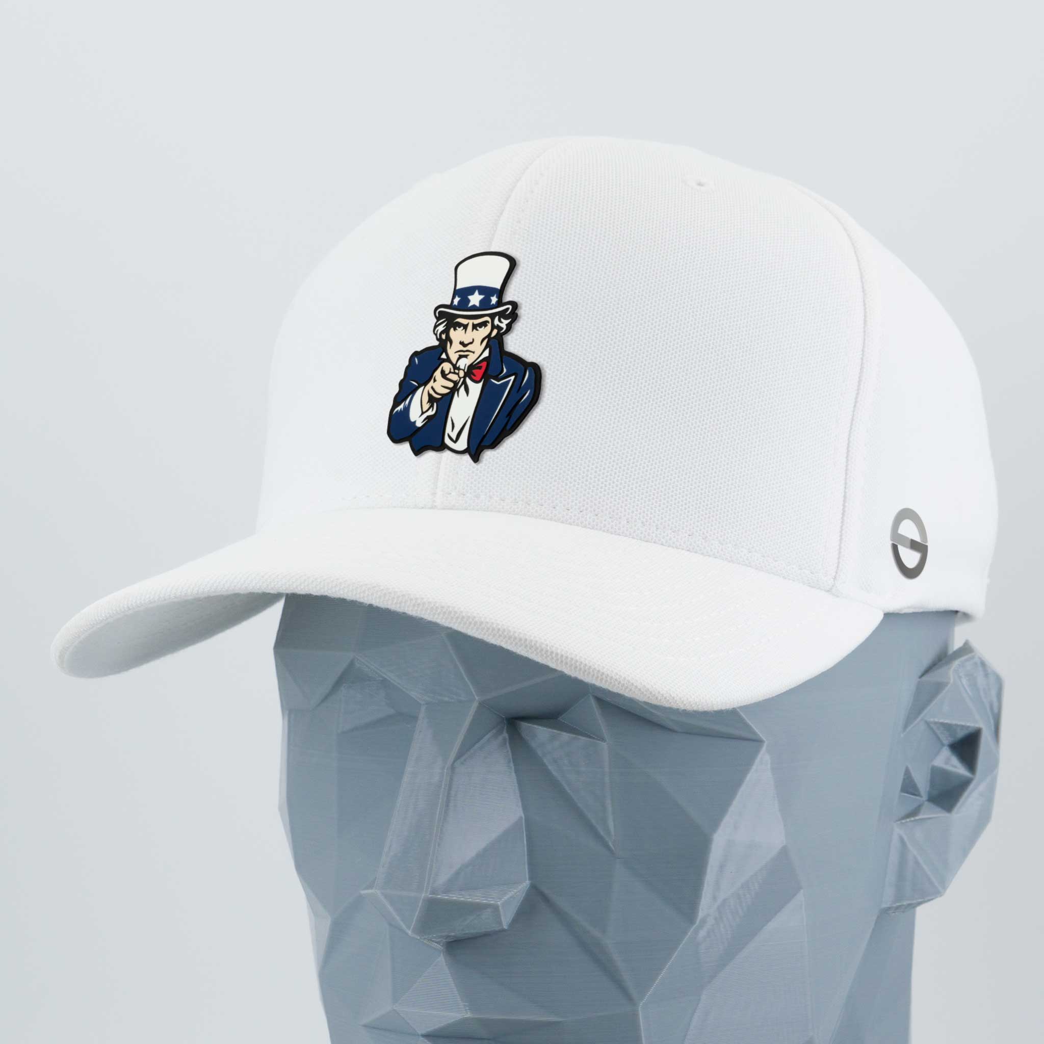 The Uncle Sam, I Want You (Silicone) Flexfit® Cool & Dry Cap by Eternal Glyph features classic American imagery—Uncle Sam pointing—embroidered on a white cap, shown on a gray geometric mannequin head.