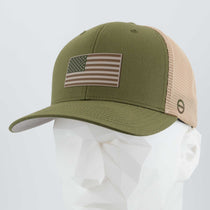 An Eternal Glyph Flexfit® Mesh Trucker Cap in Olive/Khaki, featuring a double-layer silicone camo American flag patch on the front, shown on a white geometric mannequin head.