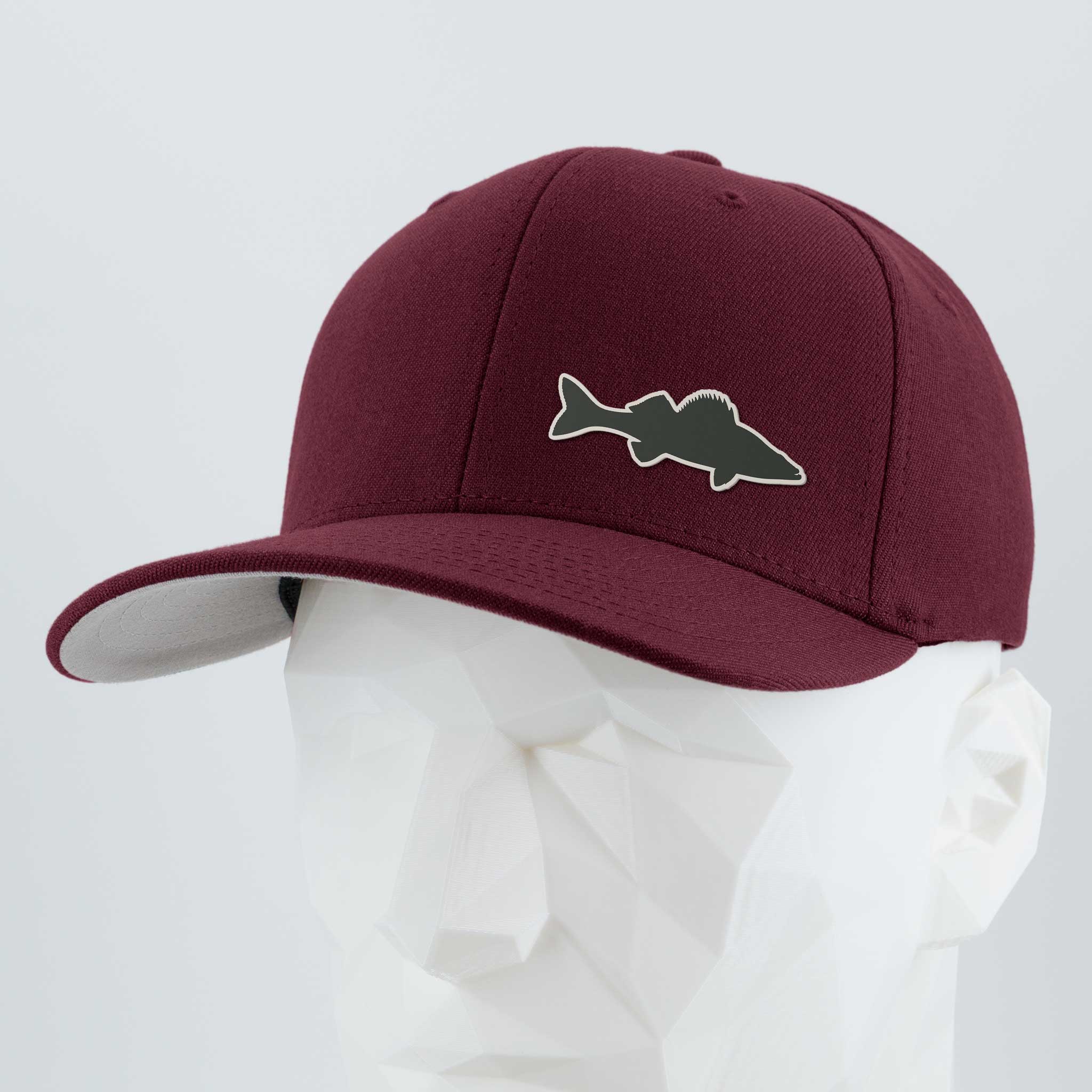 The Eternal Glyph Walleye Fishing (Silicone) Flexfit® Premium Wool Blend Cap in maroon features a fish-shaped patch, shown on a white geometric mannequin head with a light gray background—perfect for walleye anglers.