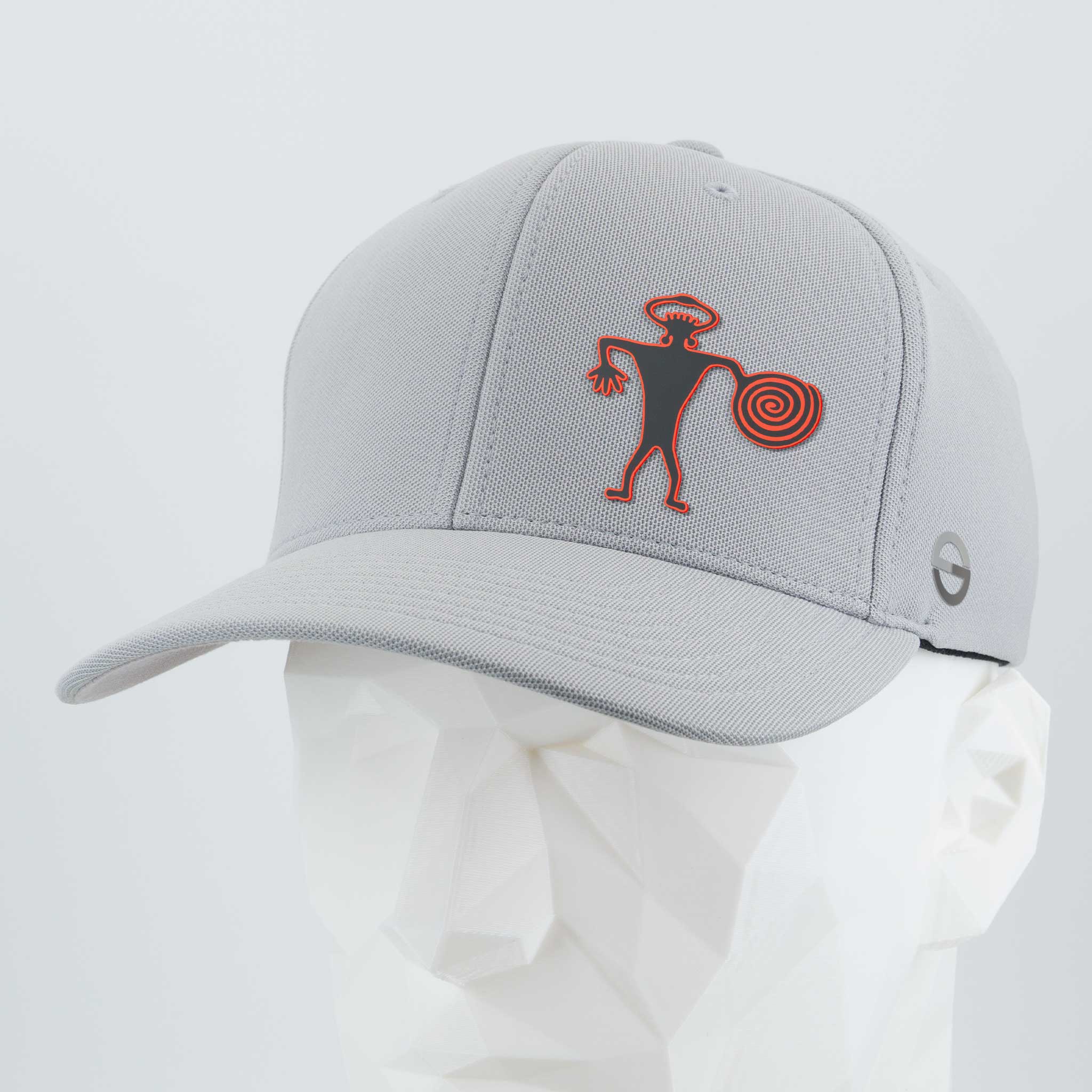 The Eternal Glyph Spiral Warrior Petroglyph (Silicone) Flexfit® Cool & Dry Cap in Silver features a red and black Moab-inspired design on the front panel, shown here displayed on a white geometric mannequin head.